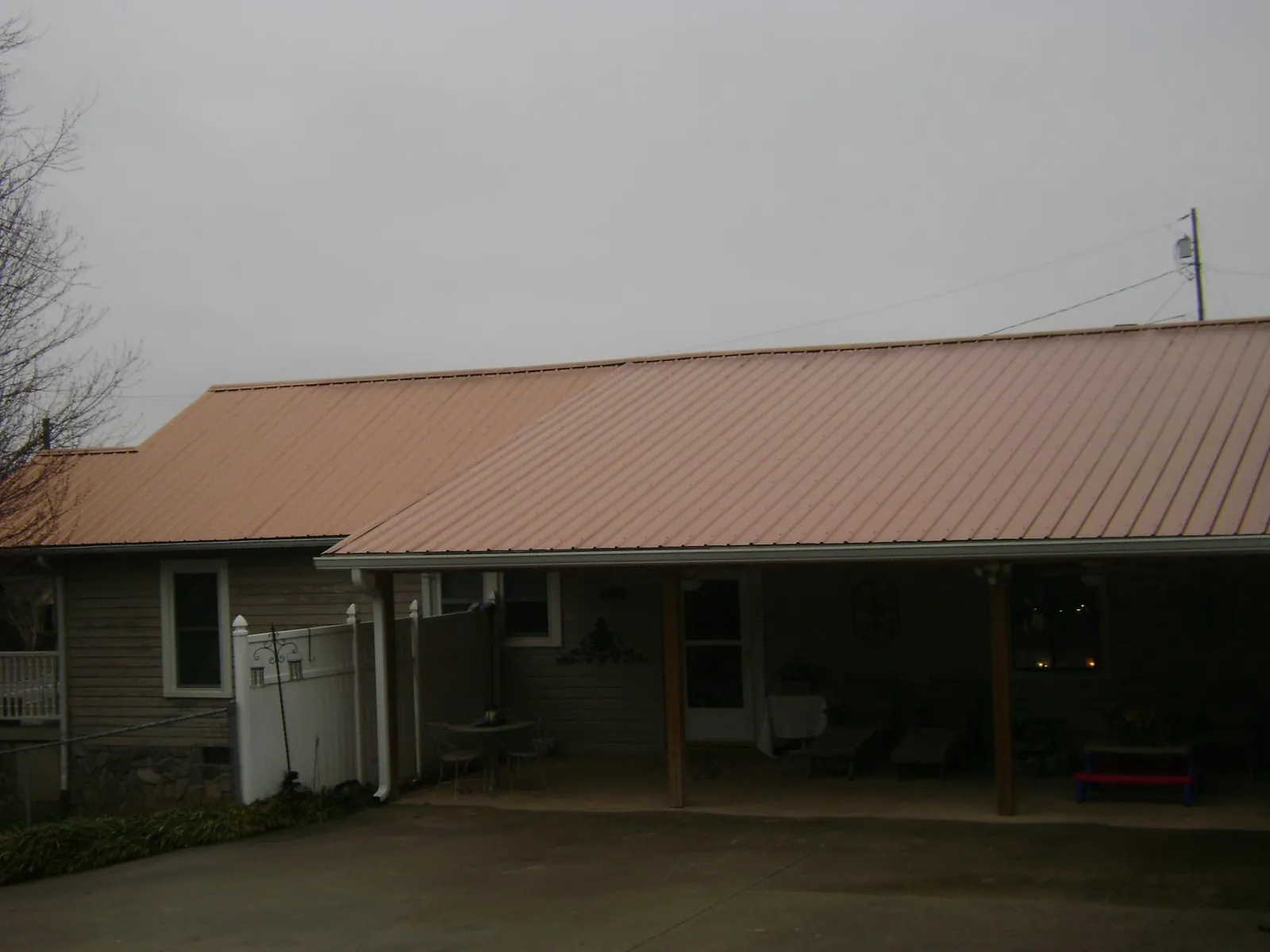 Copper toned metal roof over a wide covered patio in Piedmont